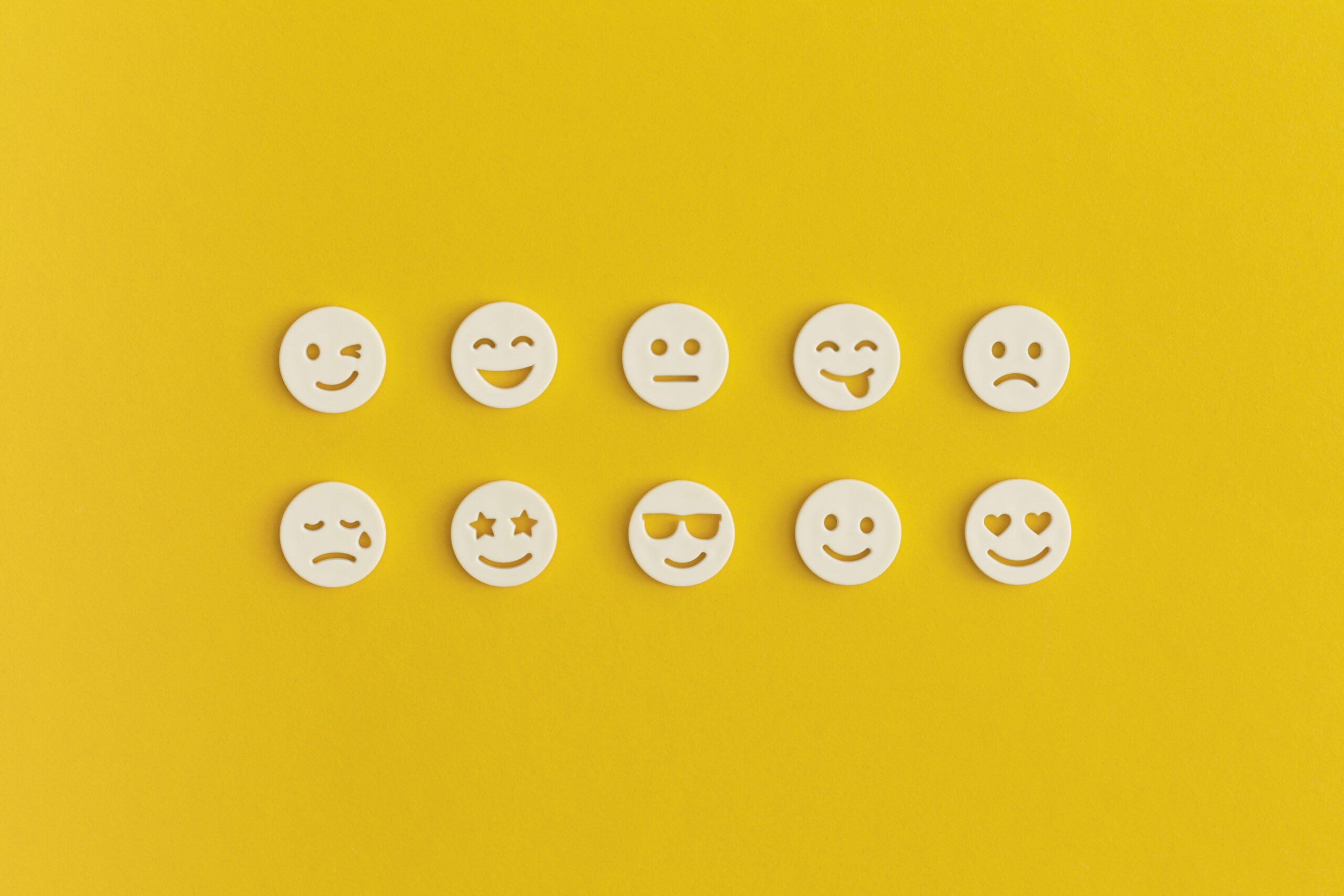 Emoticon smile on a yellow background. Customer feedback.